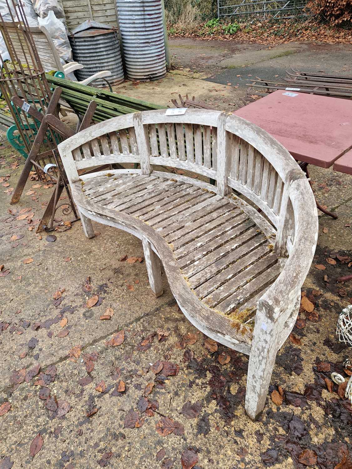 Lot 751 - A good quality teak garden bench with curved back