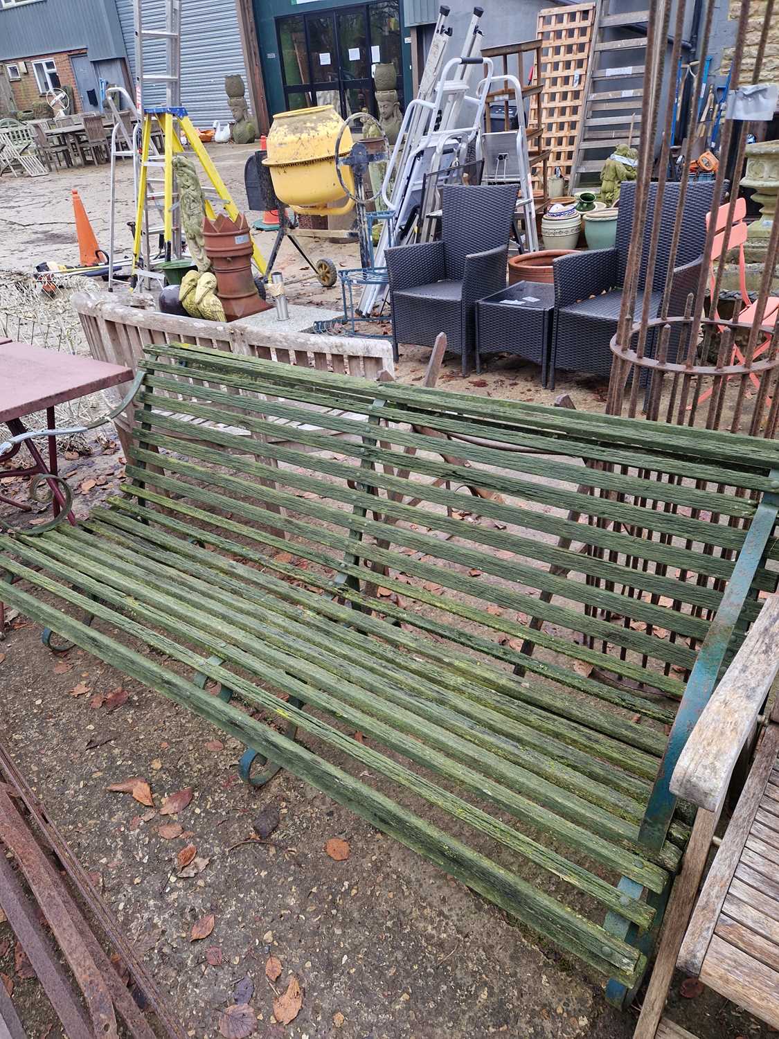 Lot 760 - A large garden bench with green-painted iron...