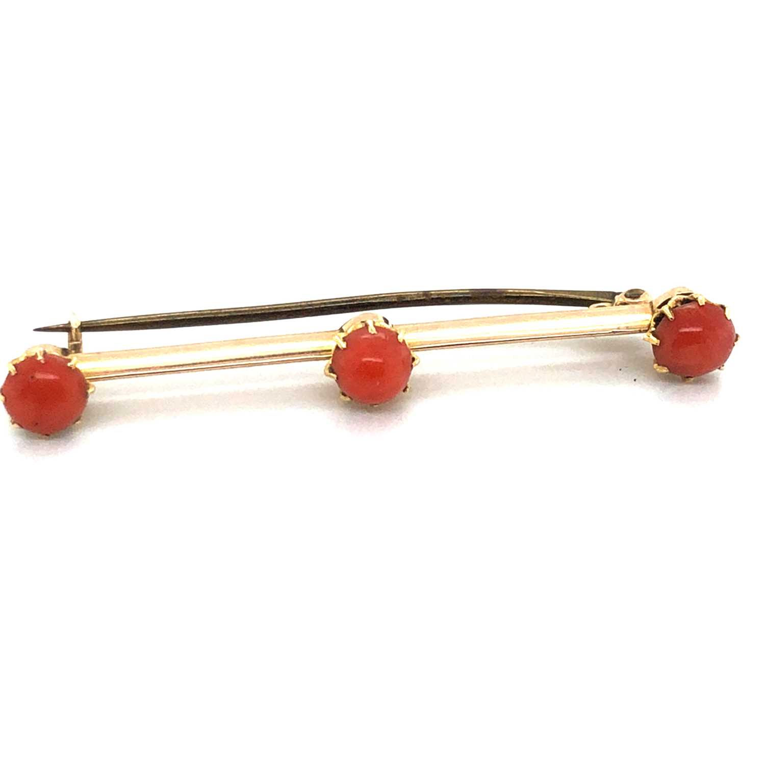Lot 44 - An antique cabochon coral bar brooch....