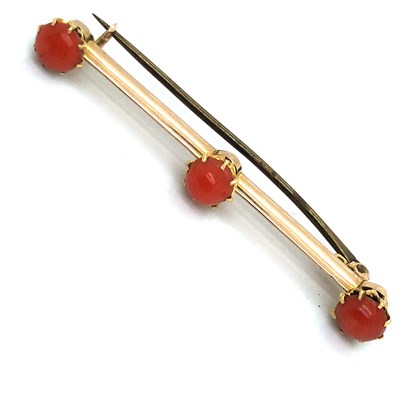 Lot 44 - An antique cabochon coral bar brooch....