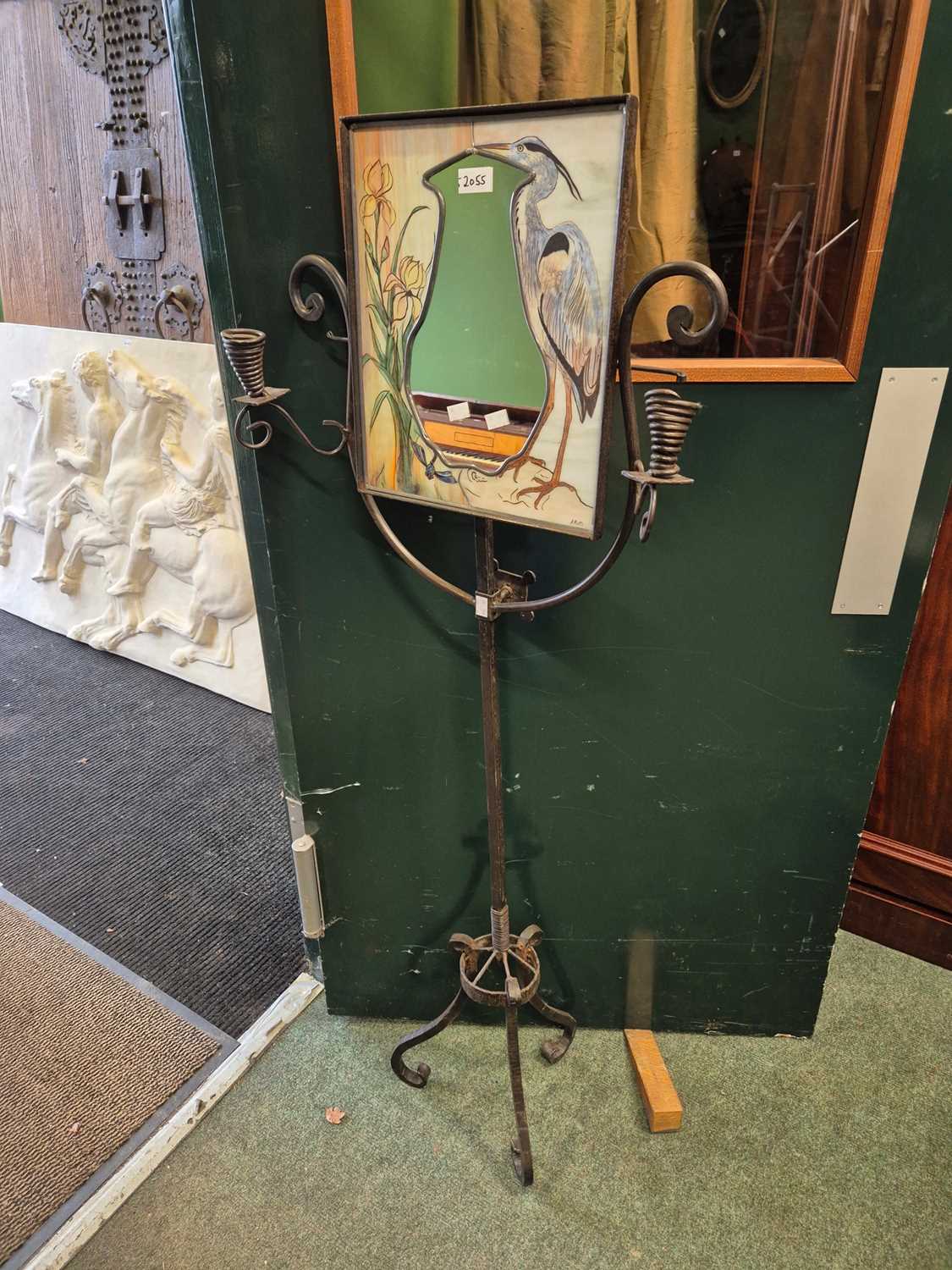 Lot 2055 - A wrought iron floor standing mirror with two...