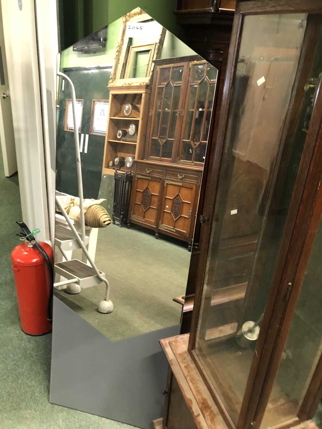 Lot 2065 - A full length wall mirror with triangular...