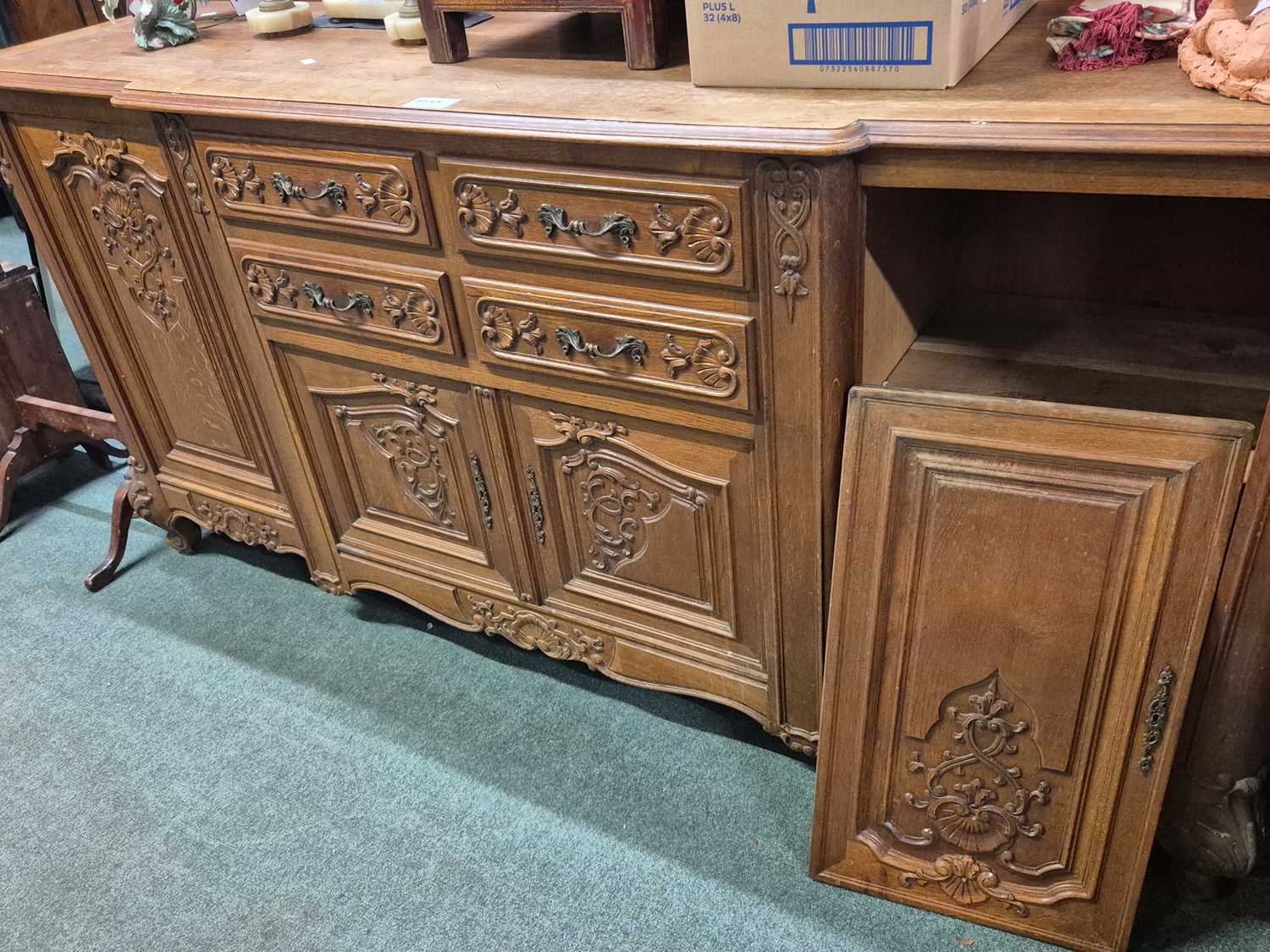 Lot 2069 - An oak side cabinet with central shell and...