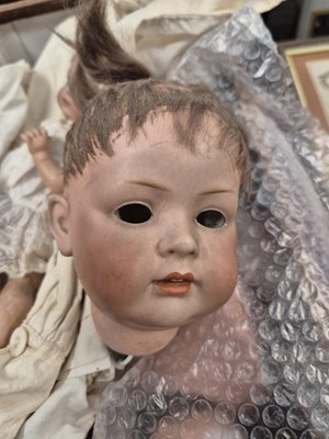 Lot 2144 - Three German bisque doll's heads with body...