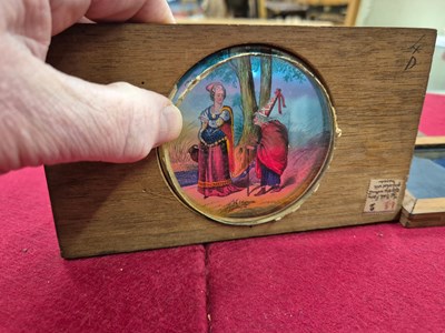 Lot 212 - A collection of antique hand-coloured magic...