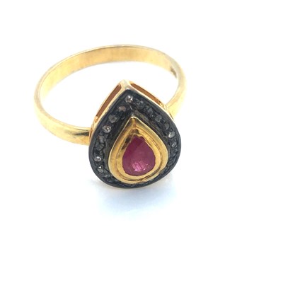 Lot 114 - A pear-shaped ring set with a pear-shaped ruby...