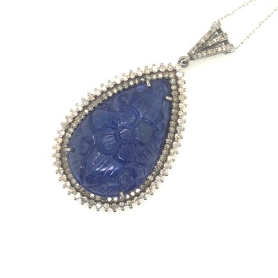 Lot 82 - A large pear-shaped carved tanzanite pendant...
