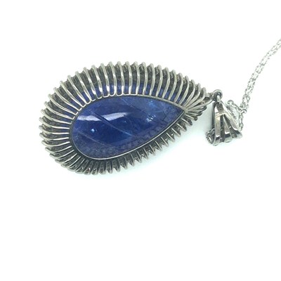 Lot 82 - A large pear-shaped carved tanzanite pendant...