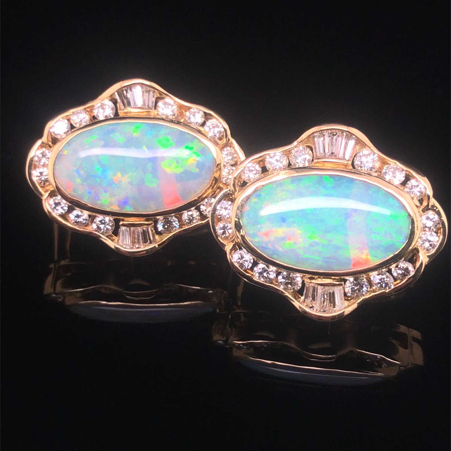 Lot 74 - A pair of opal and diamond large stud earrings...