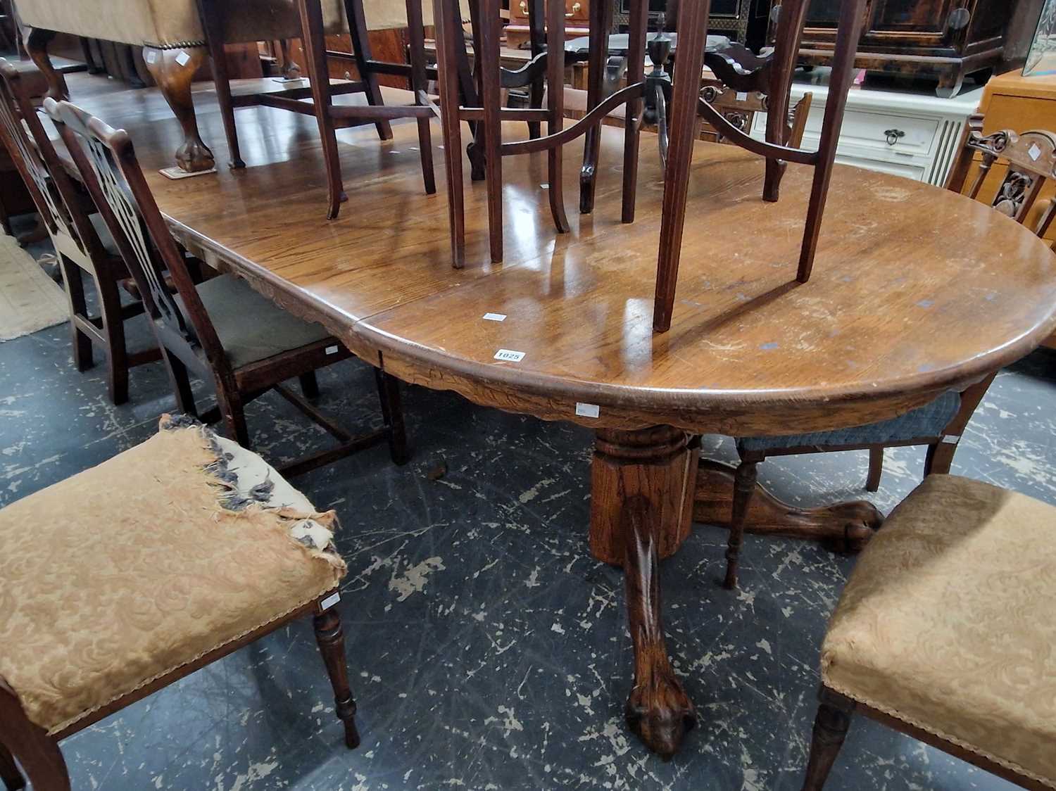 Lot 1025 - A Very large oak extending dining table on...