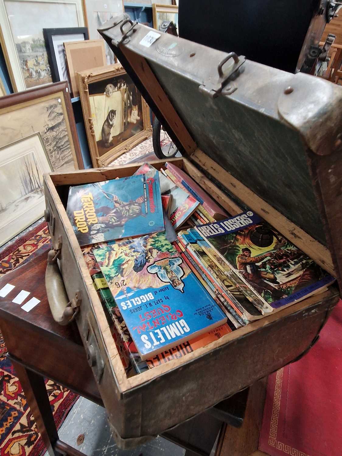 Lot 1038 - A small vintage suitcase containing Commando...