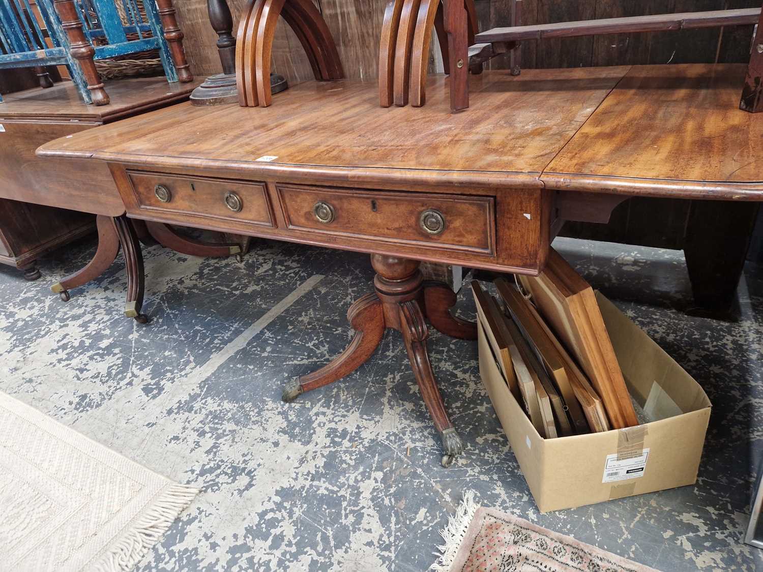 Lot 1206 - A Georgian mahogany sofa table with drop leaf...