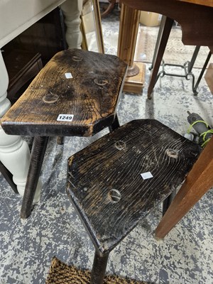 Lot 1249 - Two antique rustic milking stools.