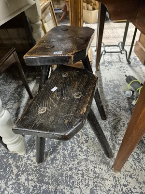 Lot 1249 - Two antique rustic milking stools.