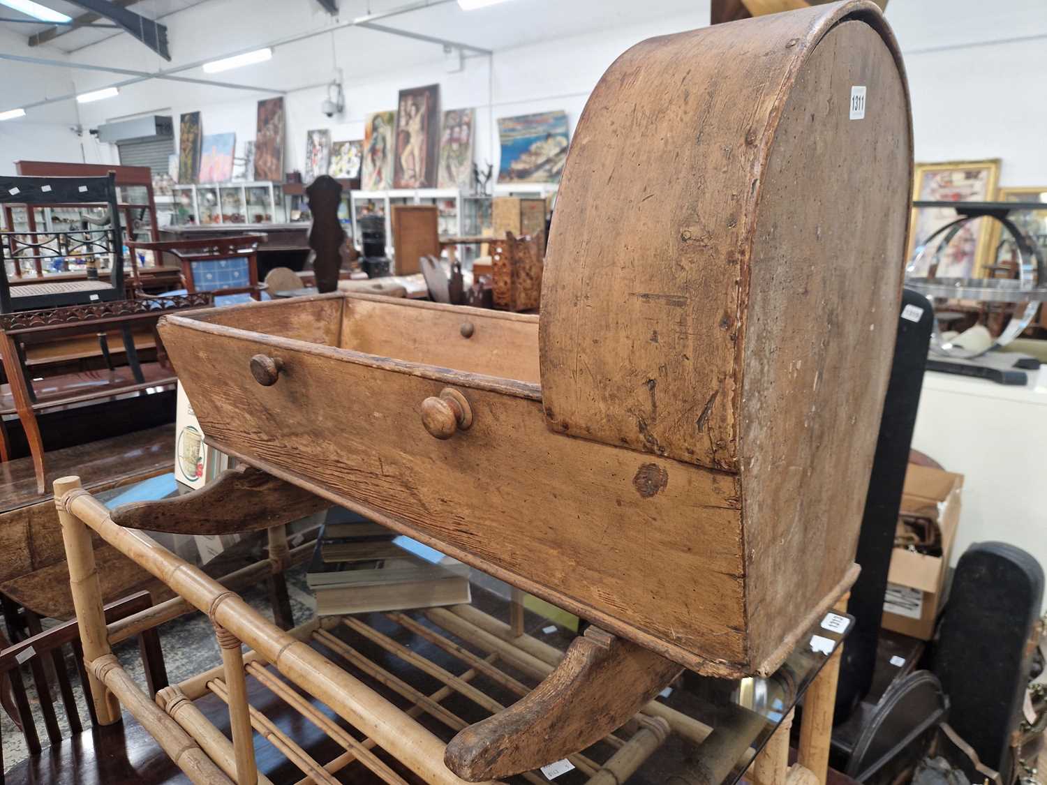 Lot 1311 - An antique country made pine rocking cradle.