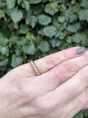 Lot 146 - A seven-stone diamond half eternity style ring,...