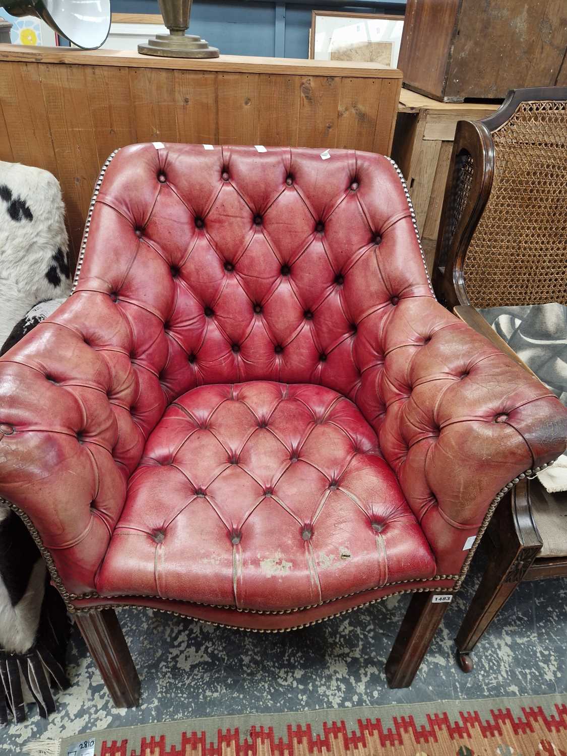 Lot 1483 - A button leather upholstered armchair.