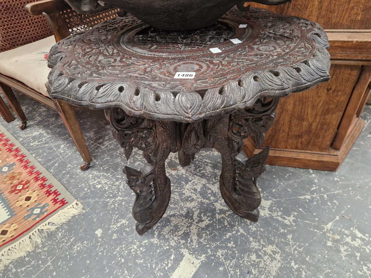 Lot 1486 - A Burmese well carved hardwood occasional table.