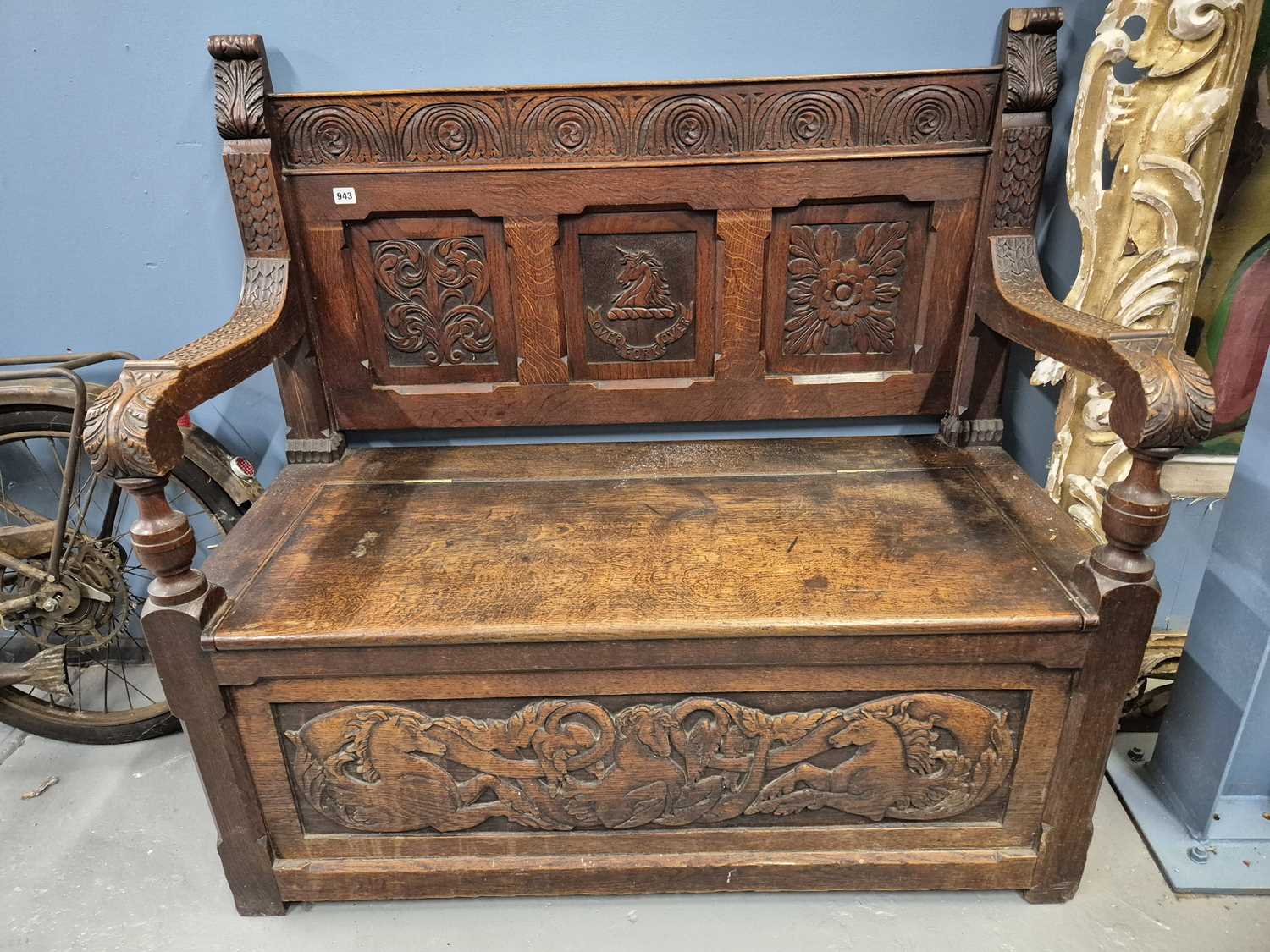 Lot 943 - A late 19th-century oak carved box seat hall...