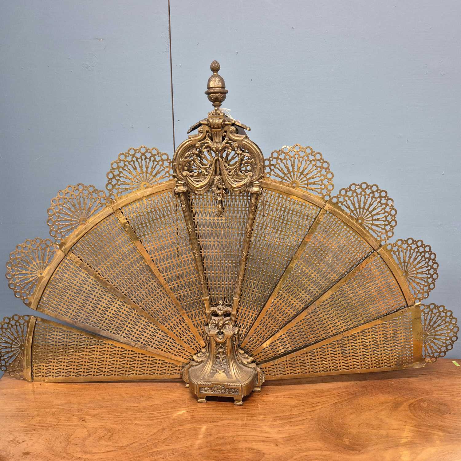 Lot 216 - A brass fire screen of eight pierced leaves...