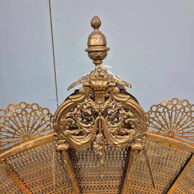 Lot 216 - A brass fire screen of eight pierced leaves...