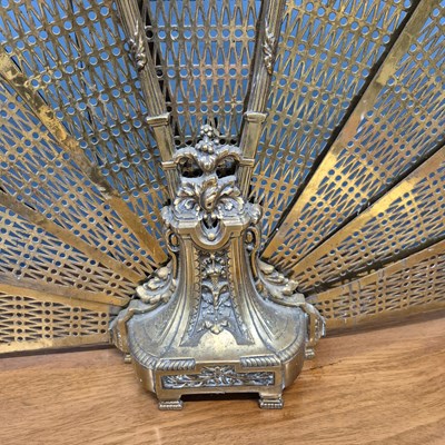 Lot 216 - A brass fire screen of eight pierced leaves...