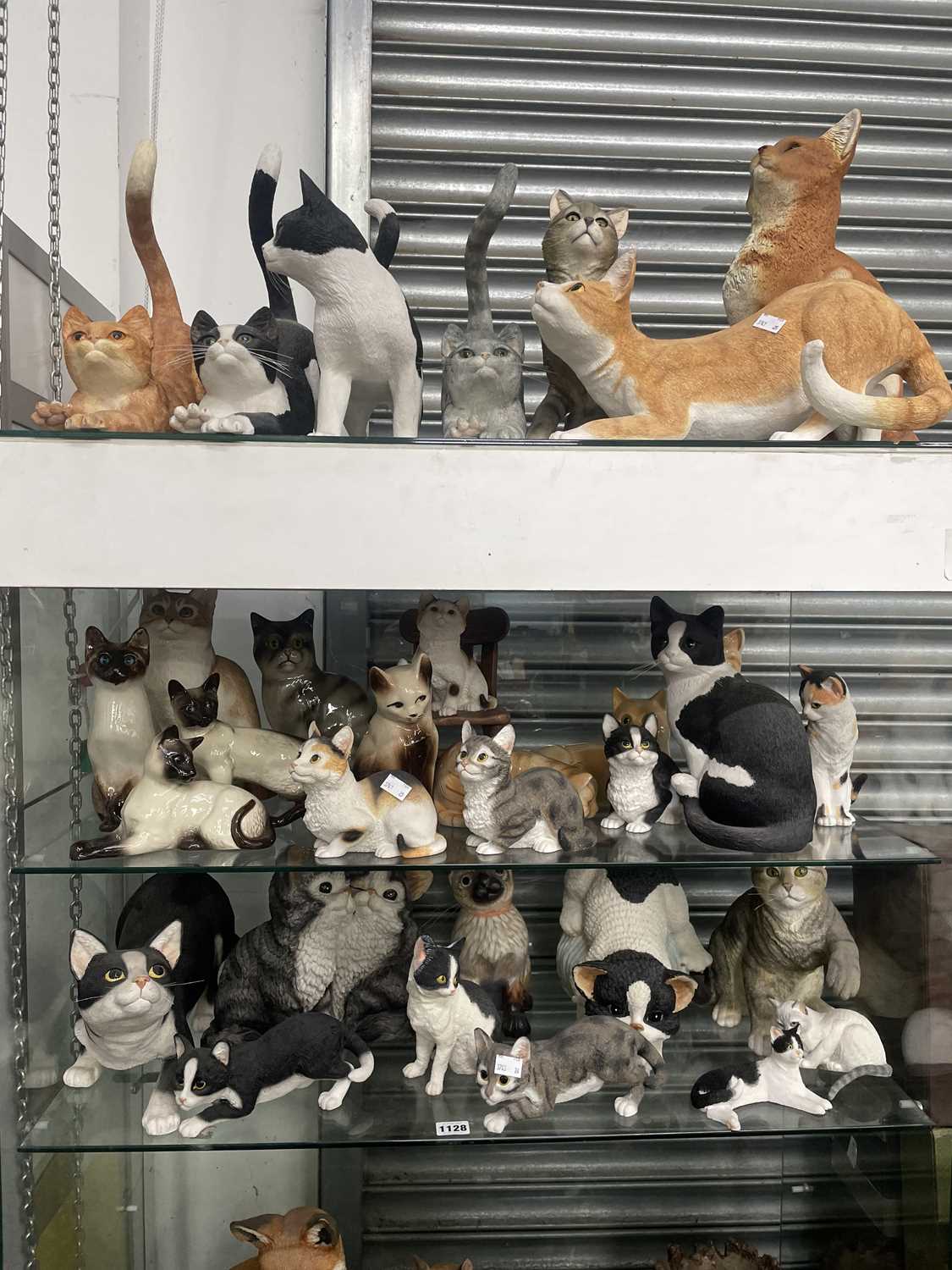 Lot 1128 - A collection of cat figurines by the Leonardo...