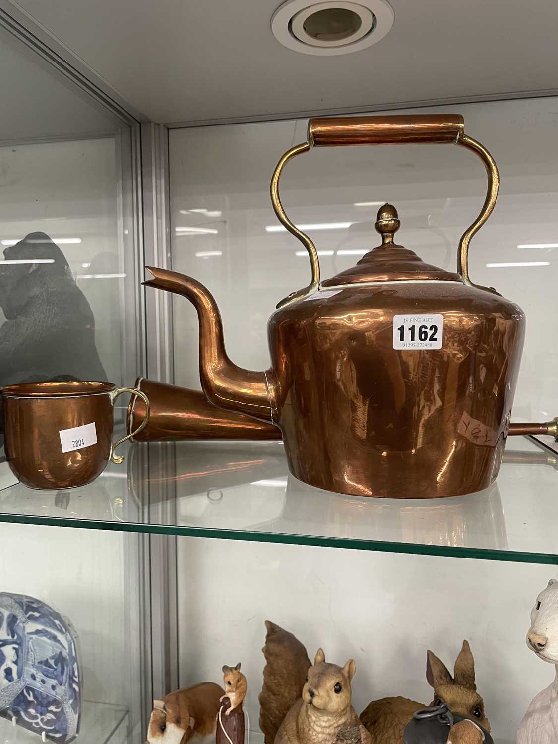 Lot 1162 - A copper horn, a cup and a copper kettle