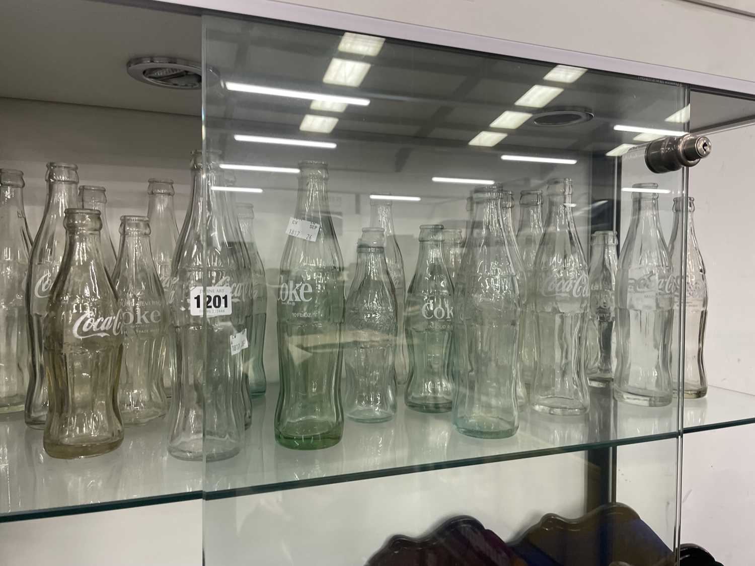 Lot 1201 - A collection of Coca Cola bottles