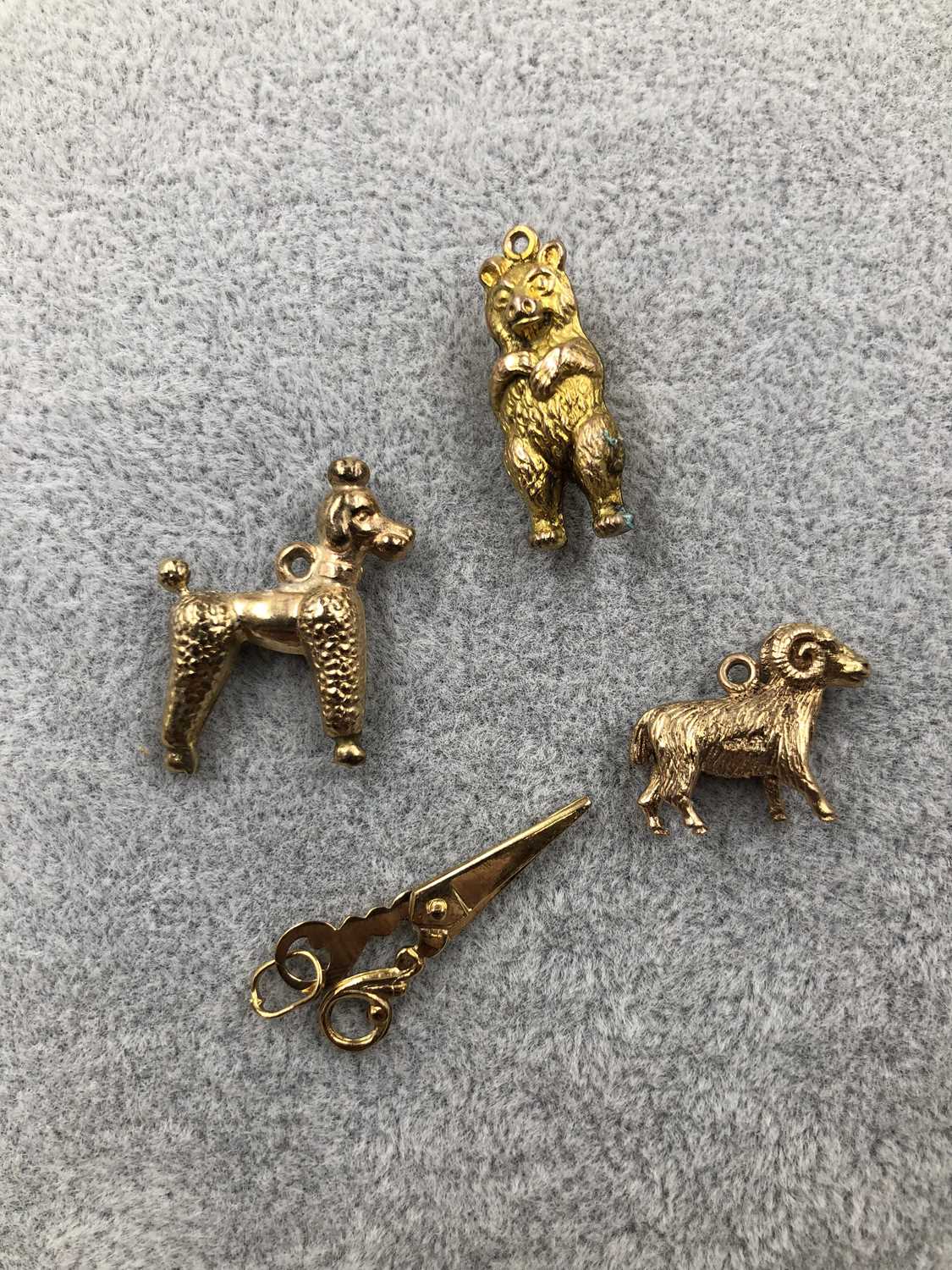 Lot 313 - Four gold charms. A 9ct hallmarked gold ram, a...