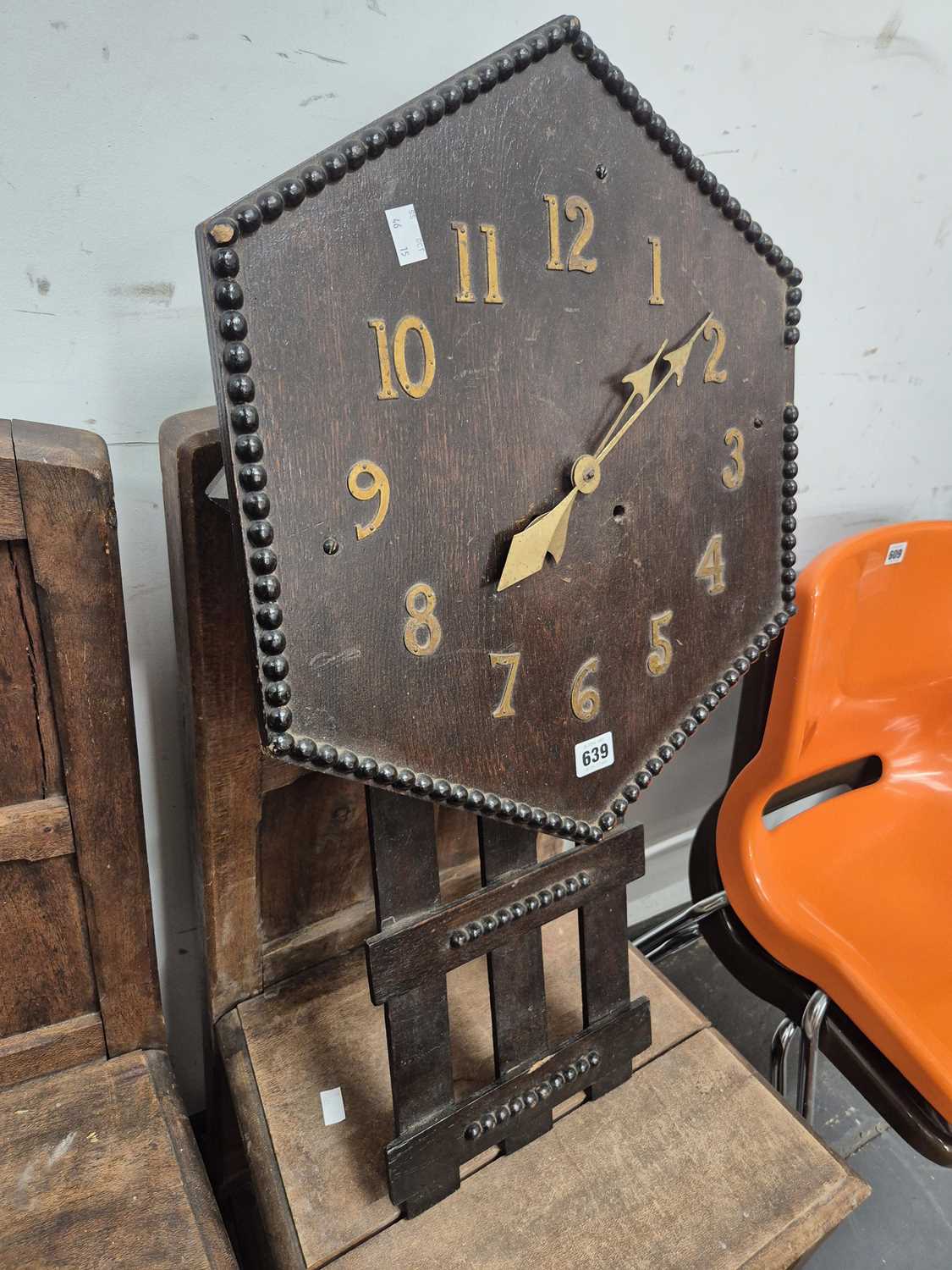 Lot 639 - An arts and crafts oak wall clock.