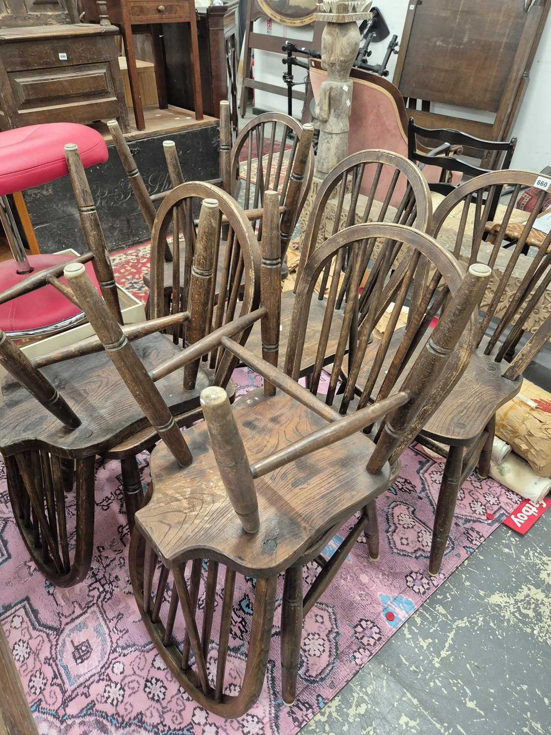 Lot 660 - A set of eight spindle back elm seat Windsor...