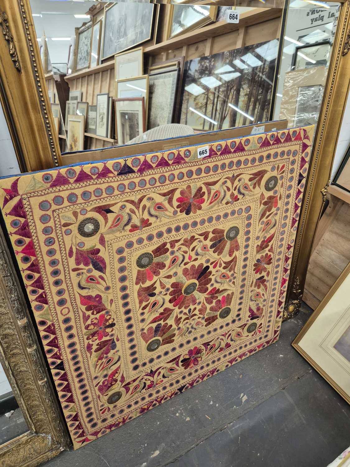 Lot 665 - An eastern embroidered panel on pine stretcher...