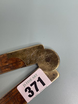 Lot 371 - An antique box wood and brass calculating rule...