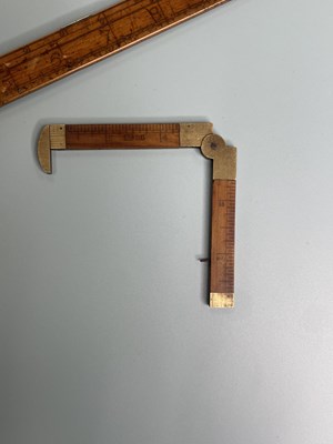 Lot 371 - An antique box wood and brass calculating rule...