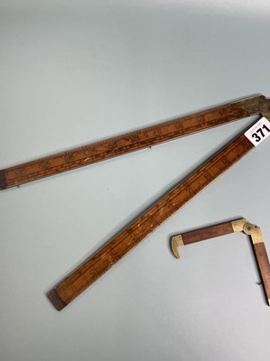 Lot 371 - An antique box wood and brass calculating rule...
