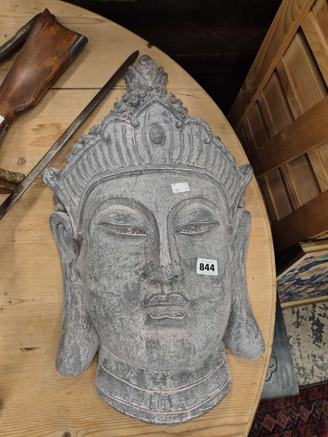 Lot 844 - A large pottery wall mask of a thai goddess.