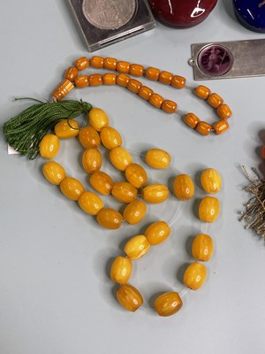Lot 389 - Four strands of various prayer beads, seven...