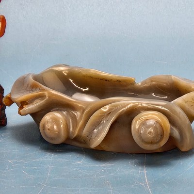 Lot 358 - A Chinese grey agate bowl carved with leaves...