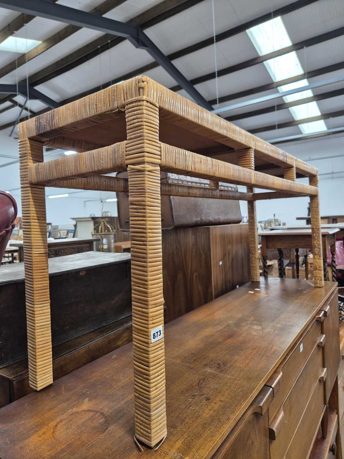 Lot 873 - A rattan console table.