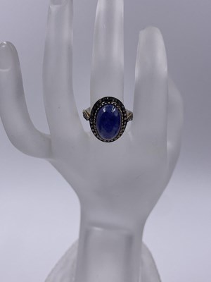 Lot 310 - A large cabochon tanzanite and rose-cut...