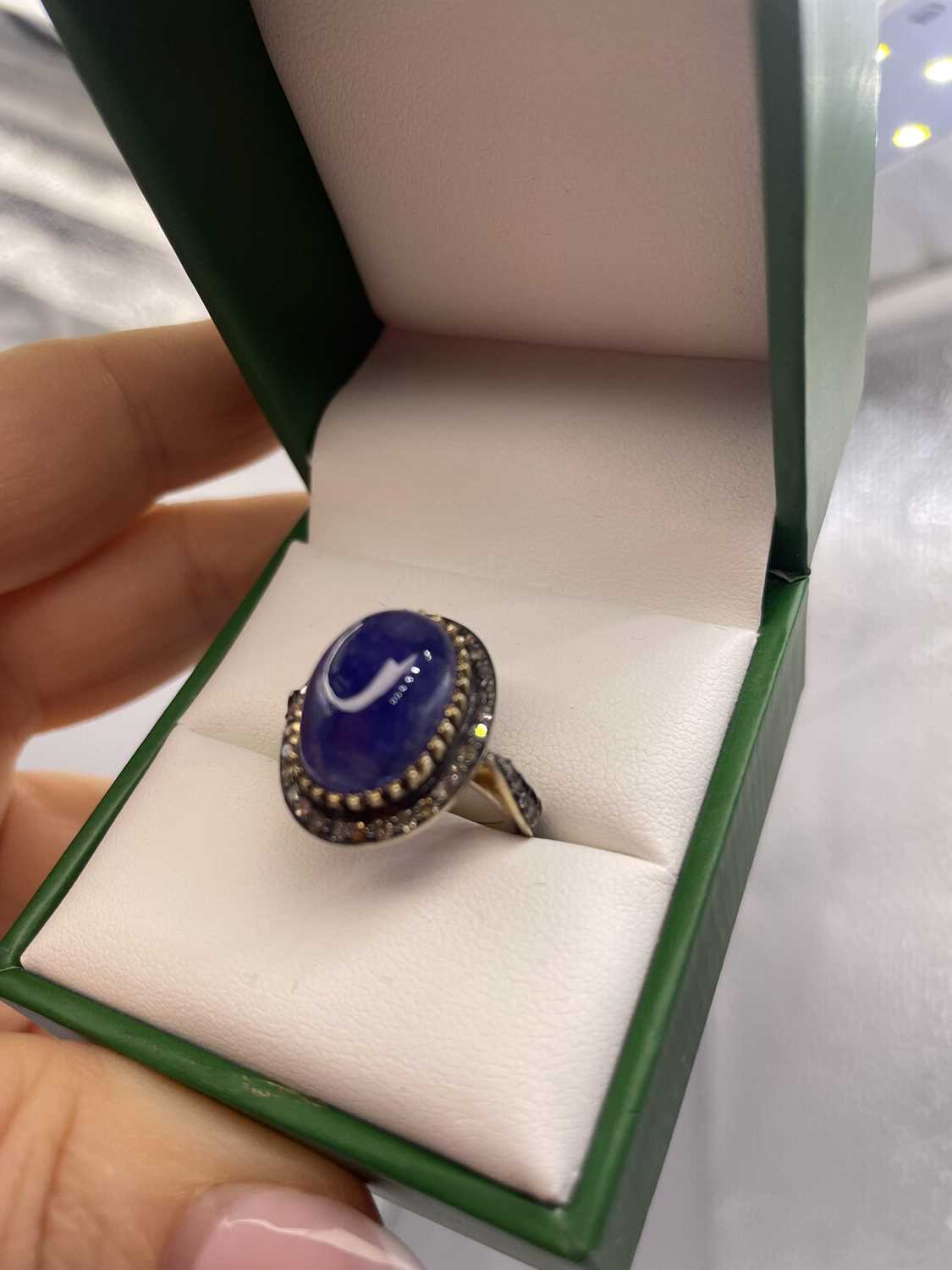 Lot 310 - A large cabochon tanzanite and rose-cut...