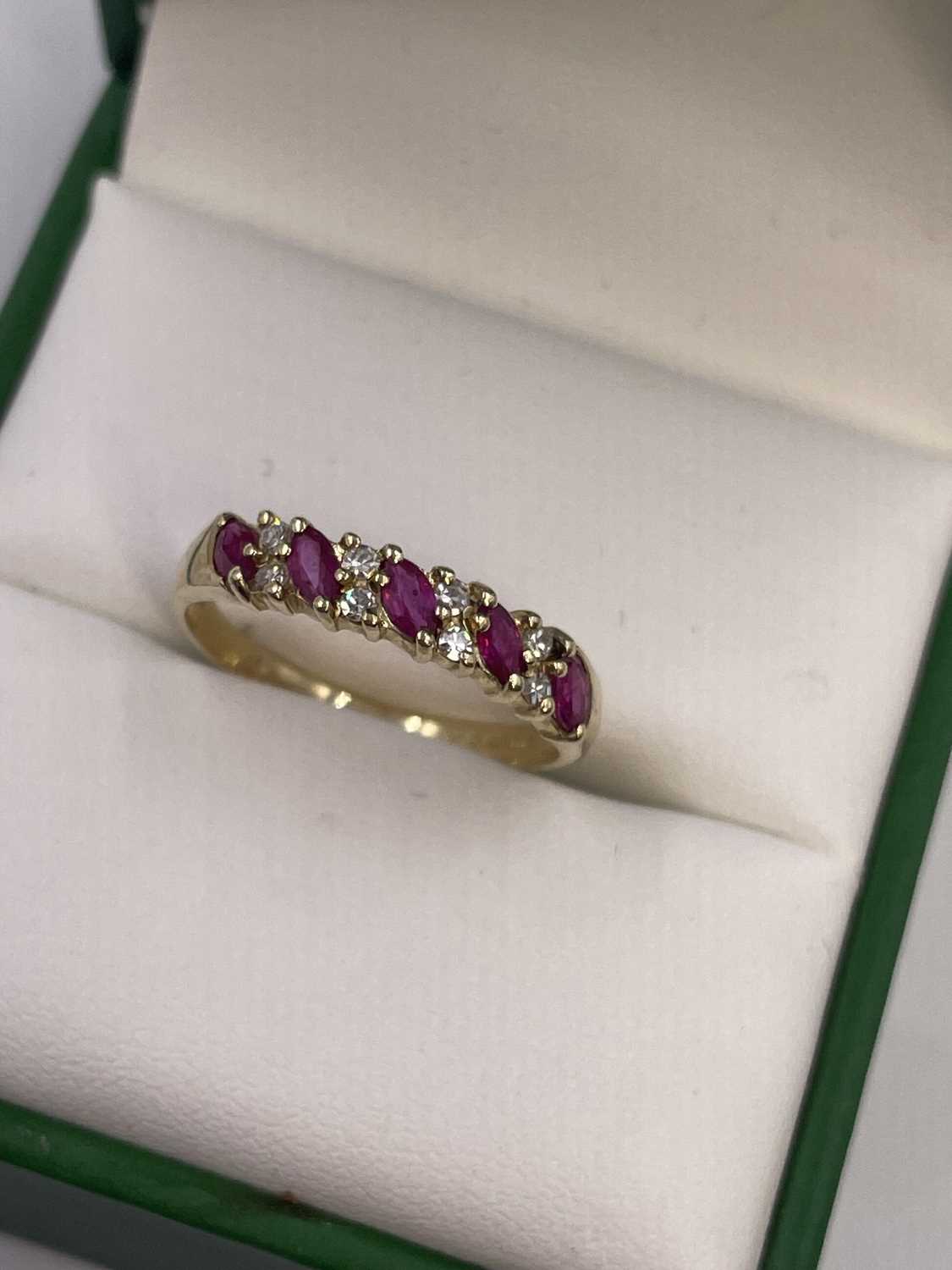 Lot 289 - A 9ct hallmarked gold nine-stone marquise ruby...