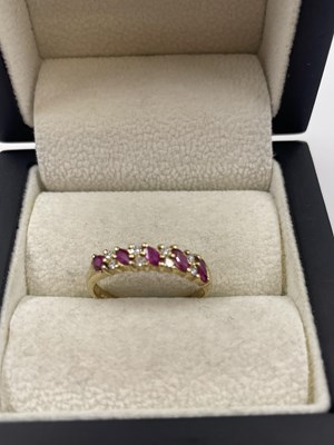 Lot 289 - A 9ct hallmarked gold nine-stone marquise ruby...