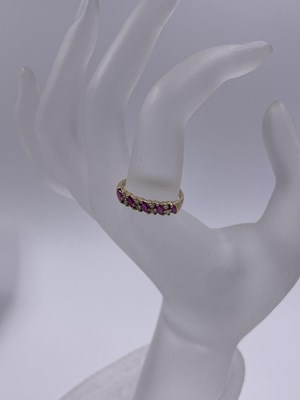 Lot 289 - A 9ct hallmarked gold nine-stone marquise ruby...