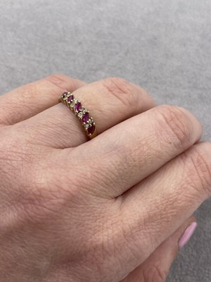 Lot 289 - A 9ct hallmarked gold nine-stone marquise ruby...