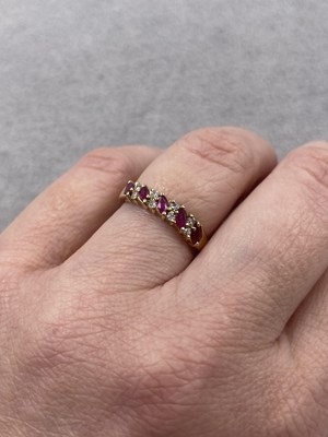 Lot 289 - A 9ct hallmarked gold nine-stone marquise ruby...