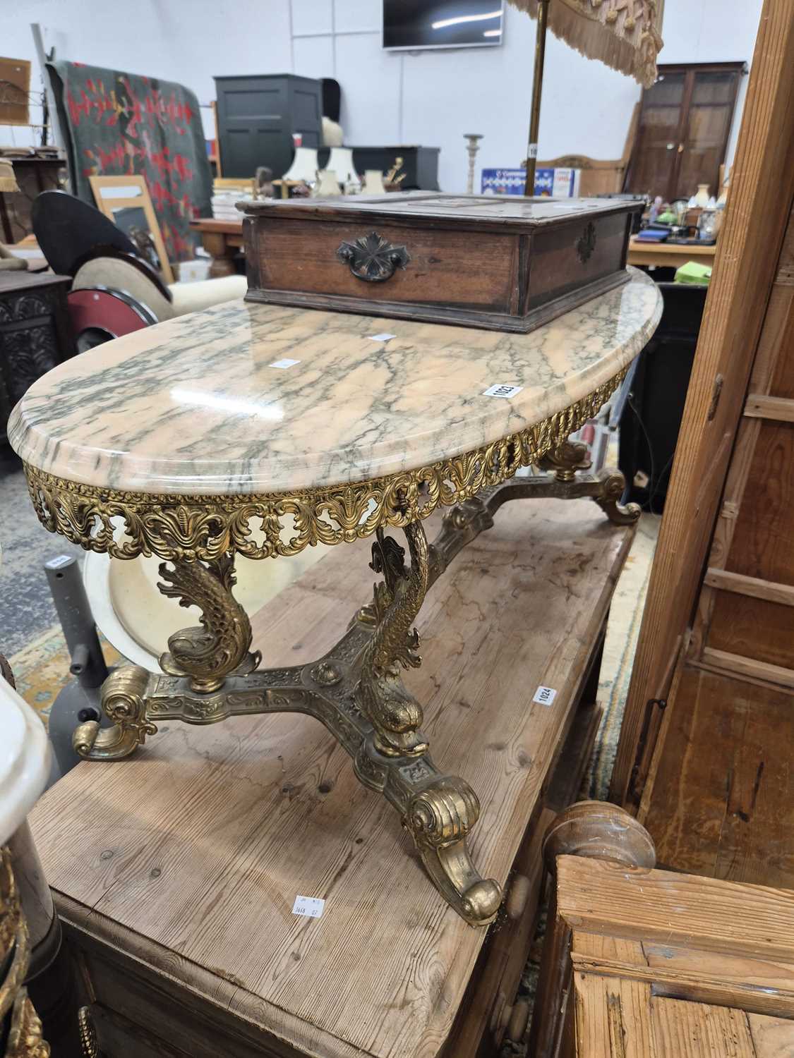 Lot 1023 - A marble-topped brass coffee table.