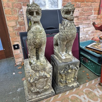 Lot 394 - A pair of reconstituted stone oriental lion...