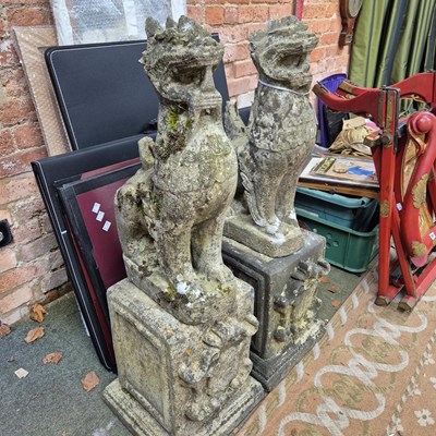 Lot 394 - A pair of reconstituted stone oriental lion...